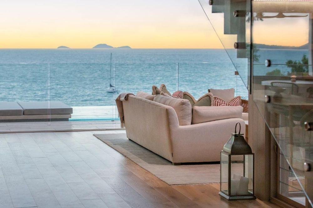 A Living Room with A Couch and A View of The Ocean — North Queensland Glass & Glazing In Hamilton Island, QLD