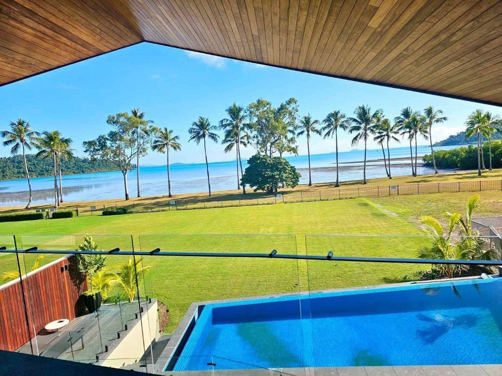 A View of The Ocean from A Balcony with A Swimming Pool — North Queensland Glass & Glazing In Airlie Beach, QLD