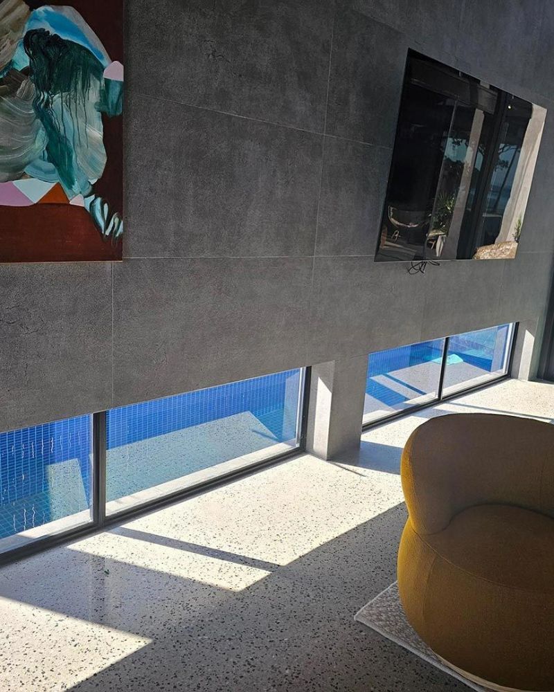A Room with A Chair and A Painting on The Wall — North Queensland Glass & Glazing In Cannonvale, QLD