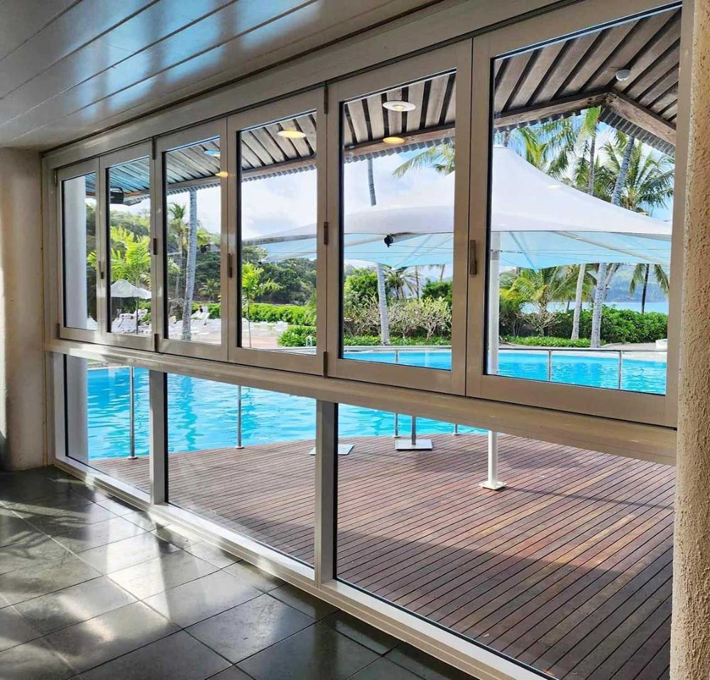 A Large Window with A View of A Swimming Pool — North Queensland Glass & Glazing In Cannonvale, QLD