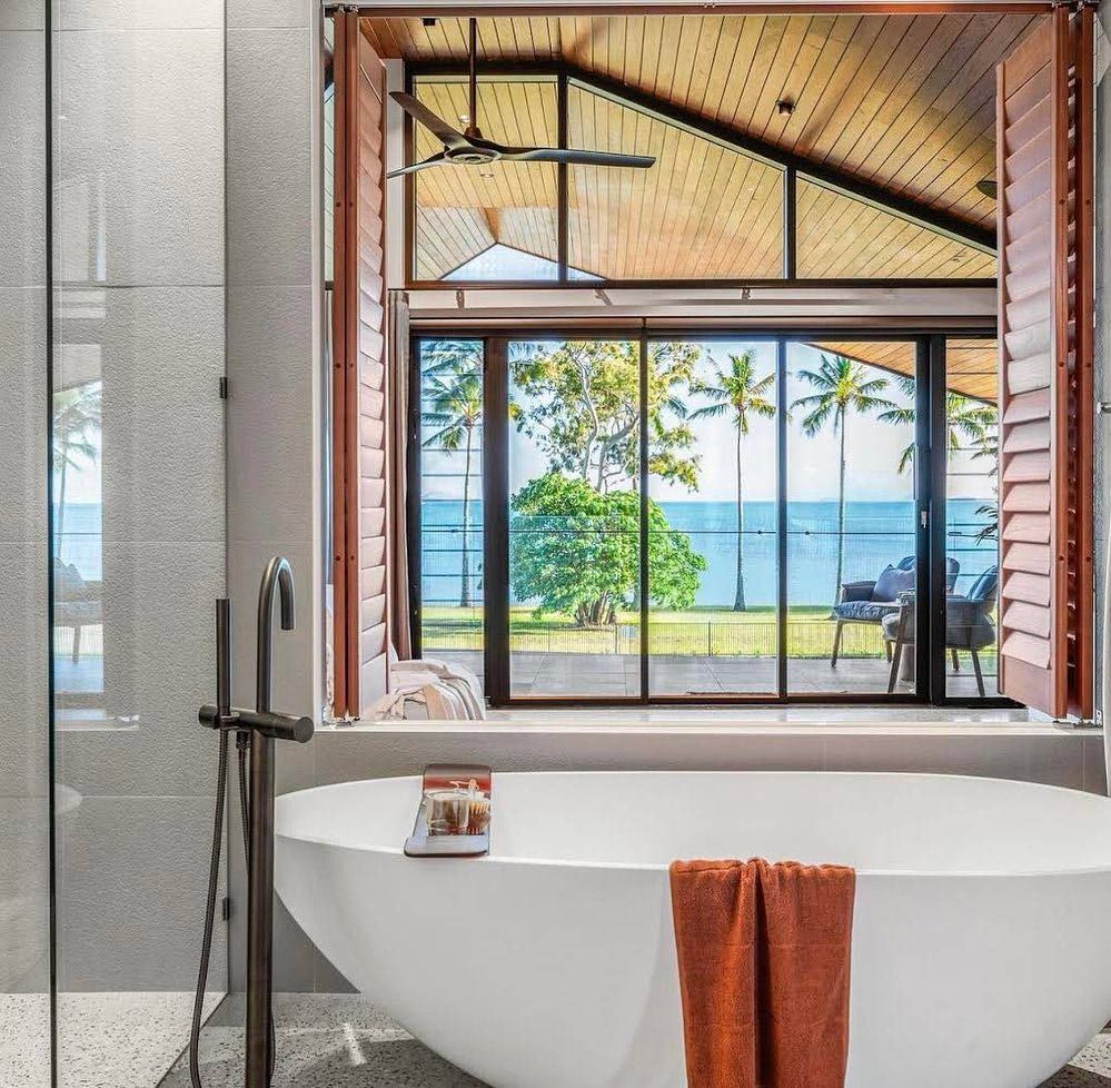 A Bathtub in A Bathroom with A View of The Ocean β North Queensland Glass & Glazing In Cannonvale, QLD