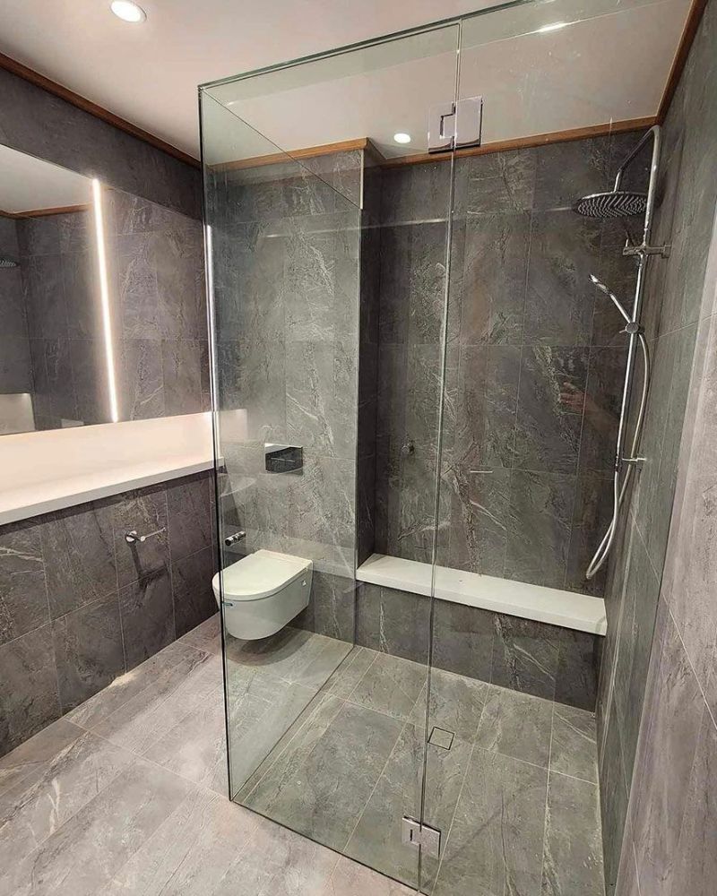 A Bathroom with A Walk in Shower, Toilet, Sink and Mirror — North Queensland Glass & Glazing In Cannonvale, QLD
