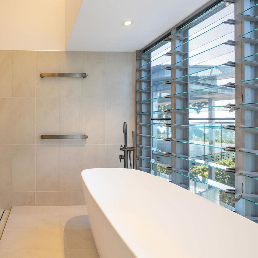 A Bathroom with A Bathtub and A Large Window — North Queensland Glass & Glazing In Cannonvale, QLD