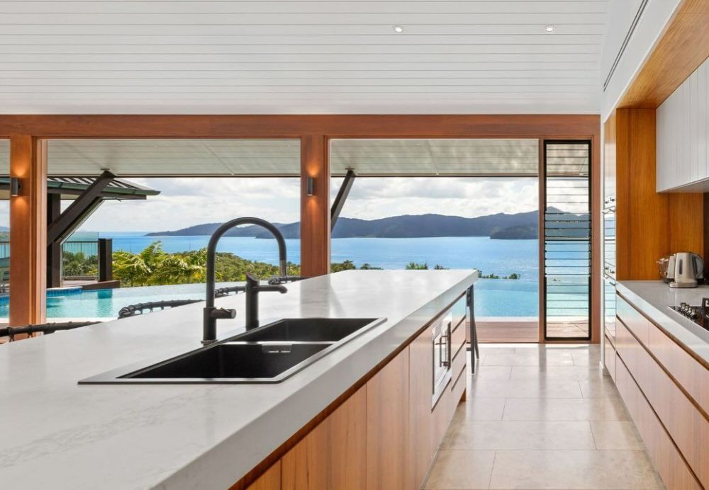 A Kitchen with A Sink and A View of The Ocean — North Queensland Glass & Glazing In Airlie Beach, QLD