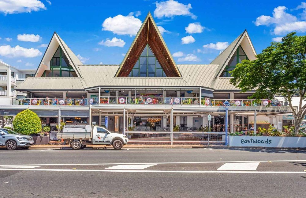 A White Truck Is Parked in Front of A Large Building — North Queensland Glass & Glazing In Cannonvale, QLD