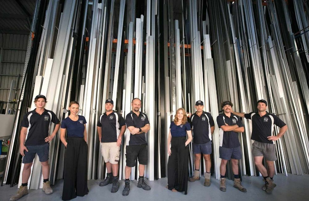 A Group of People Standing Next to Each Other — North Queensland Glass & Glazing In Cannonvale, QLD