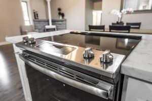 A stainless steel stove top oven is sitting on top of a kitchen counter.