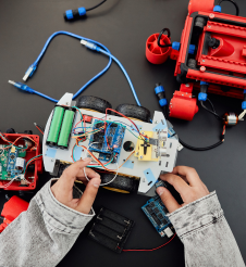 A person is working on a robot on a table.