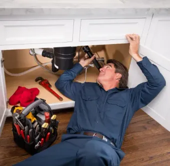 Plumber fixing sink Westminster plumbing.