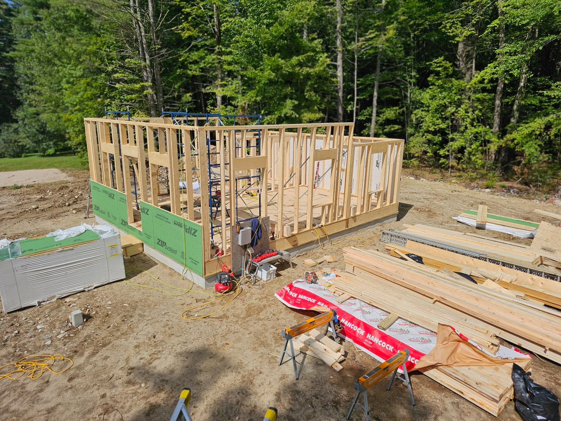 a house is being built in the woods and the walls are being built