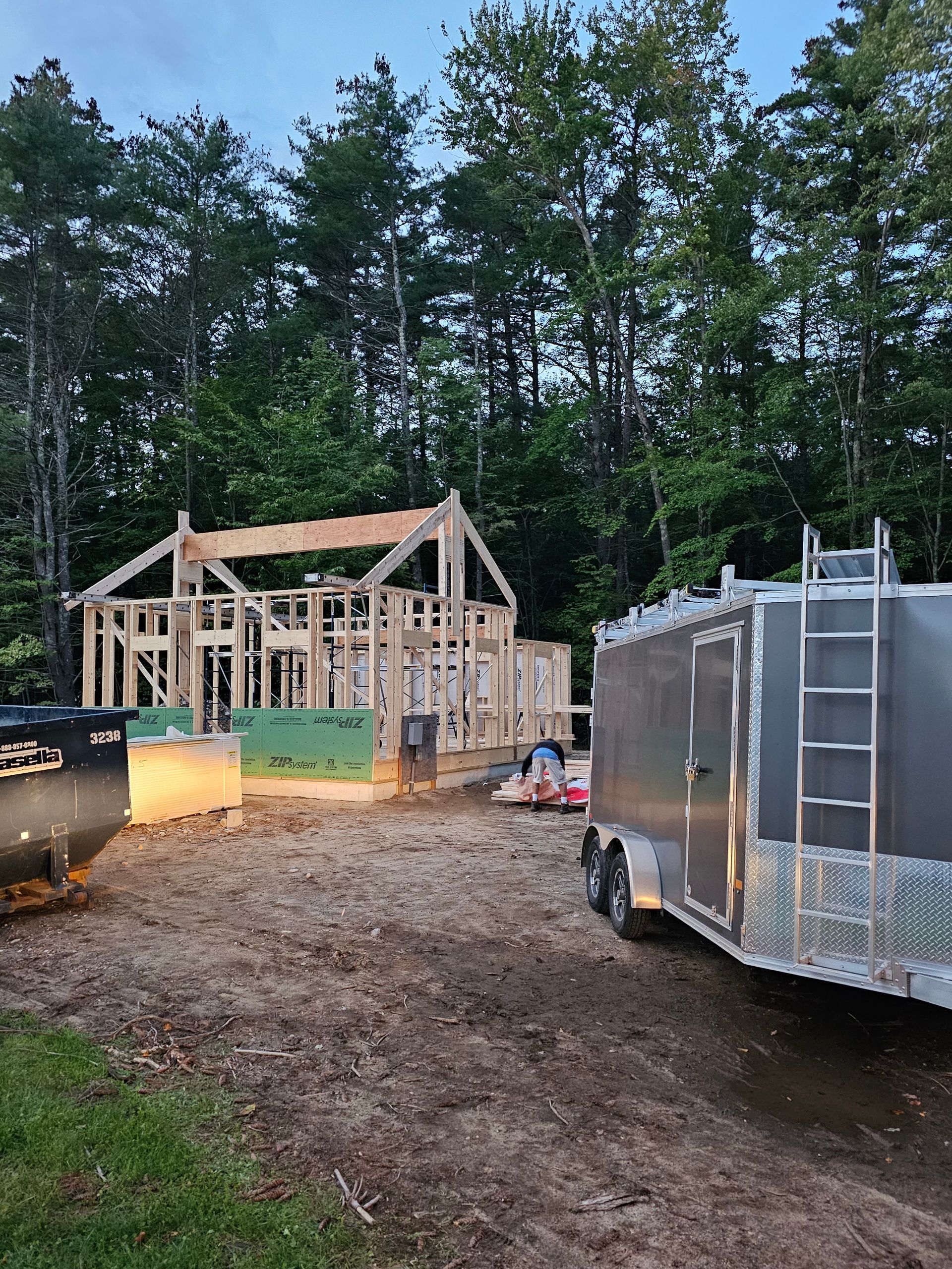 a jobsite trailer is parked in front of a house under construction