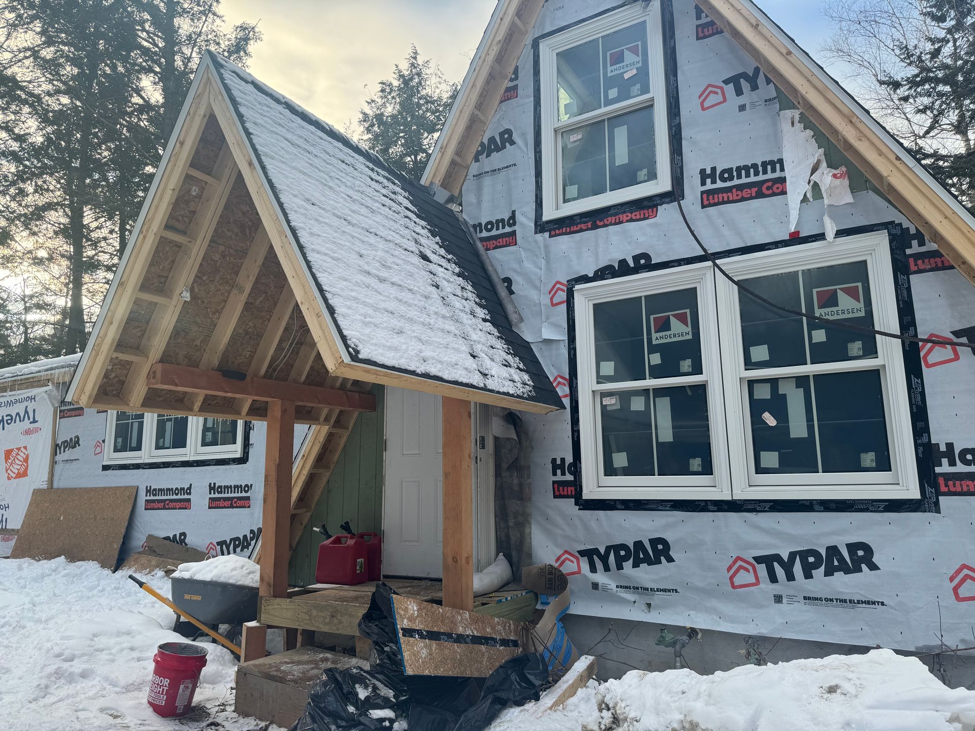 an exterior view of a house under going renovation with typar and andersen windows