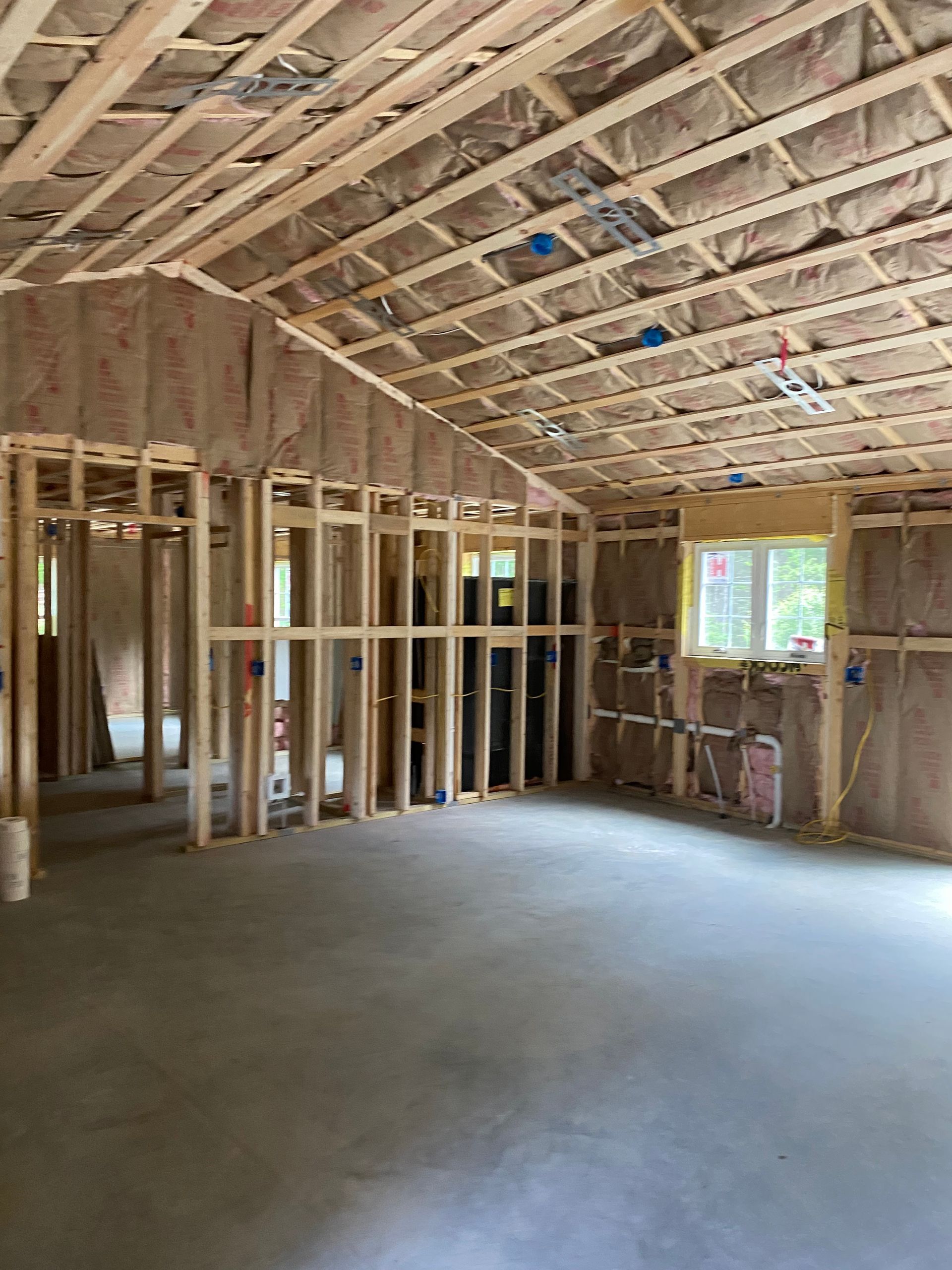 a room that is being built and has insulation on the walls and ceiling