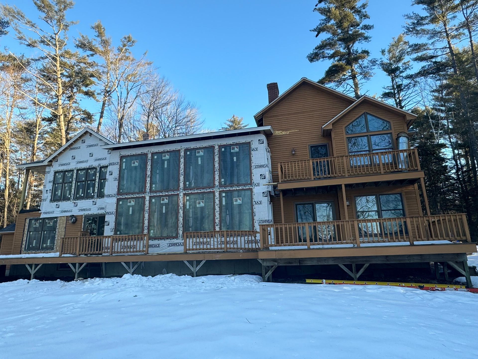 a recently remodeled house with a wall of andersen windows