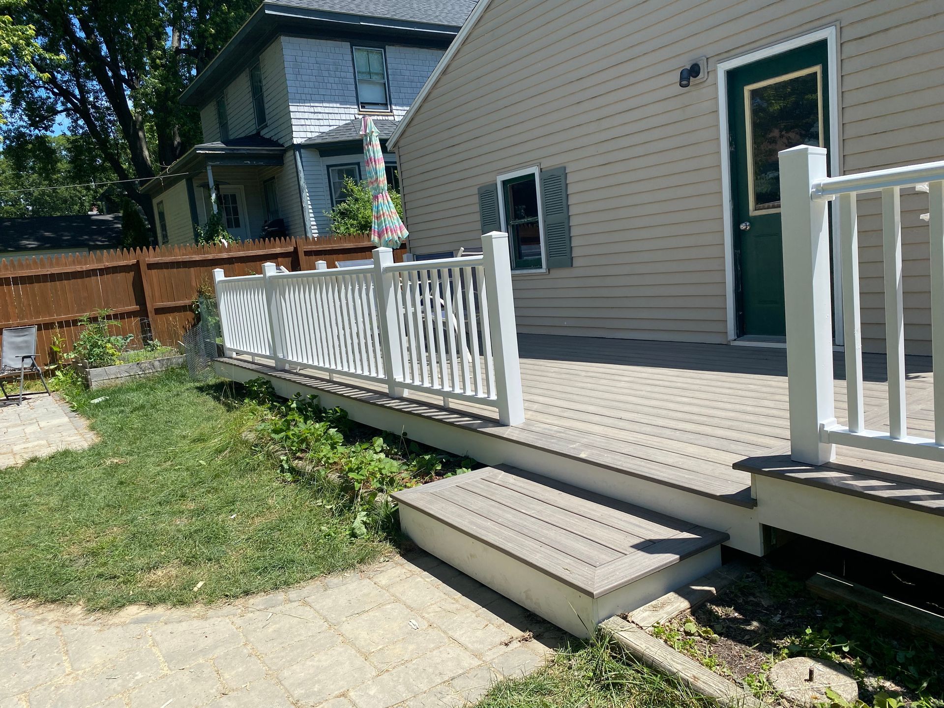 A house with a deck and stairs in front of it
