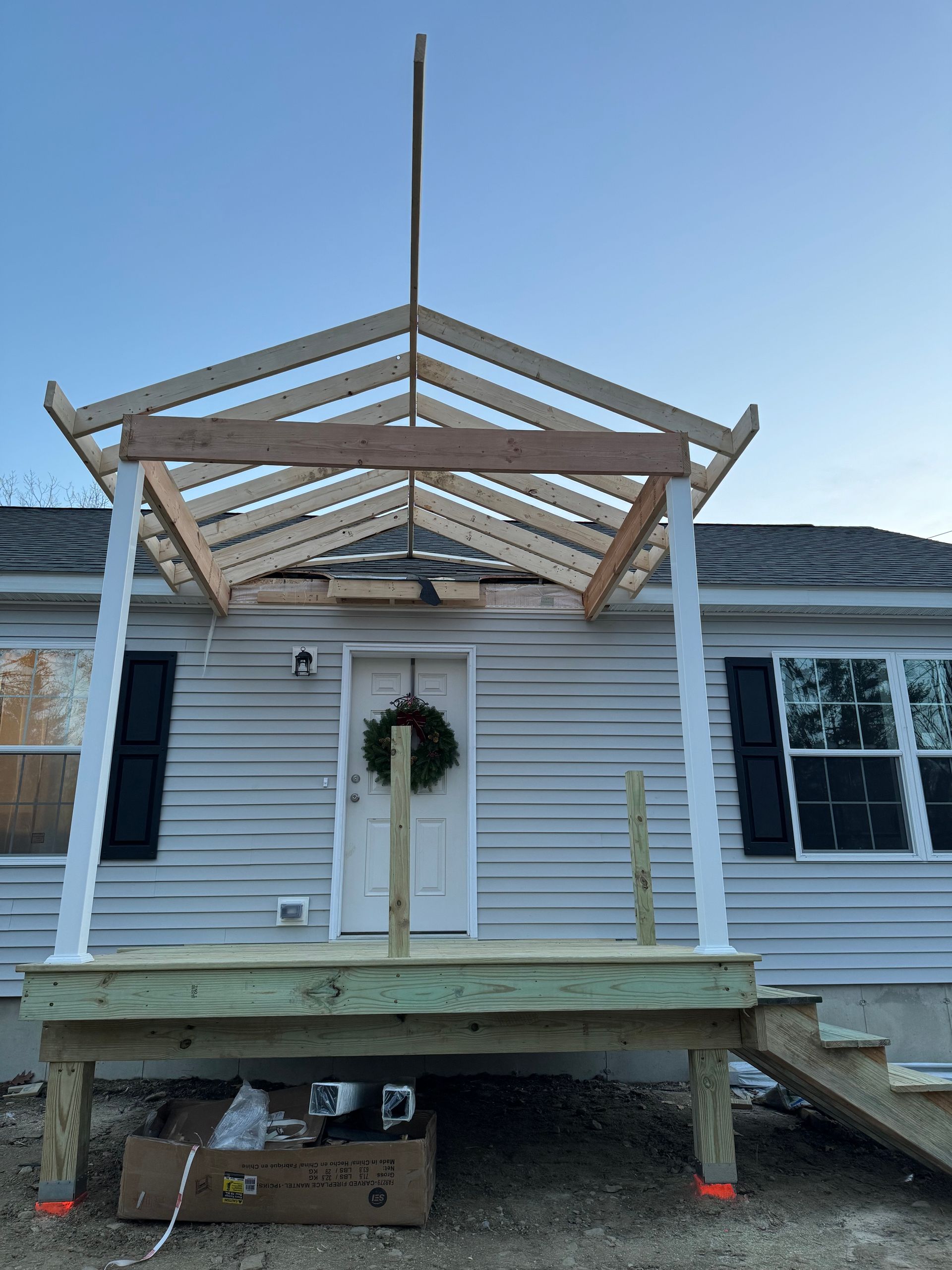 A house with a porch being built on top of it.