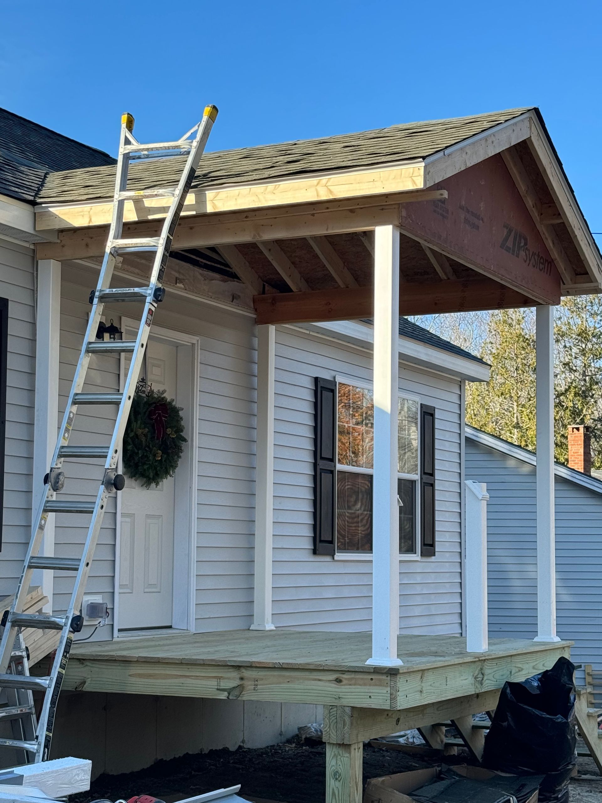 A porch is being built on the side of a house.