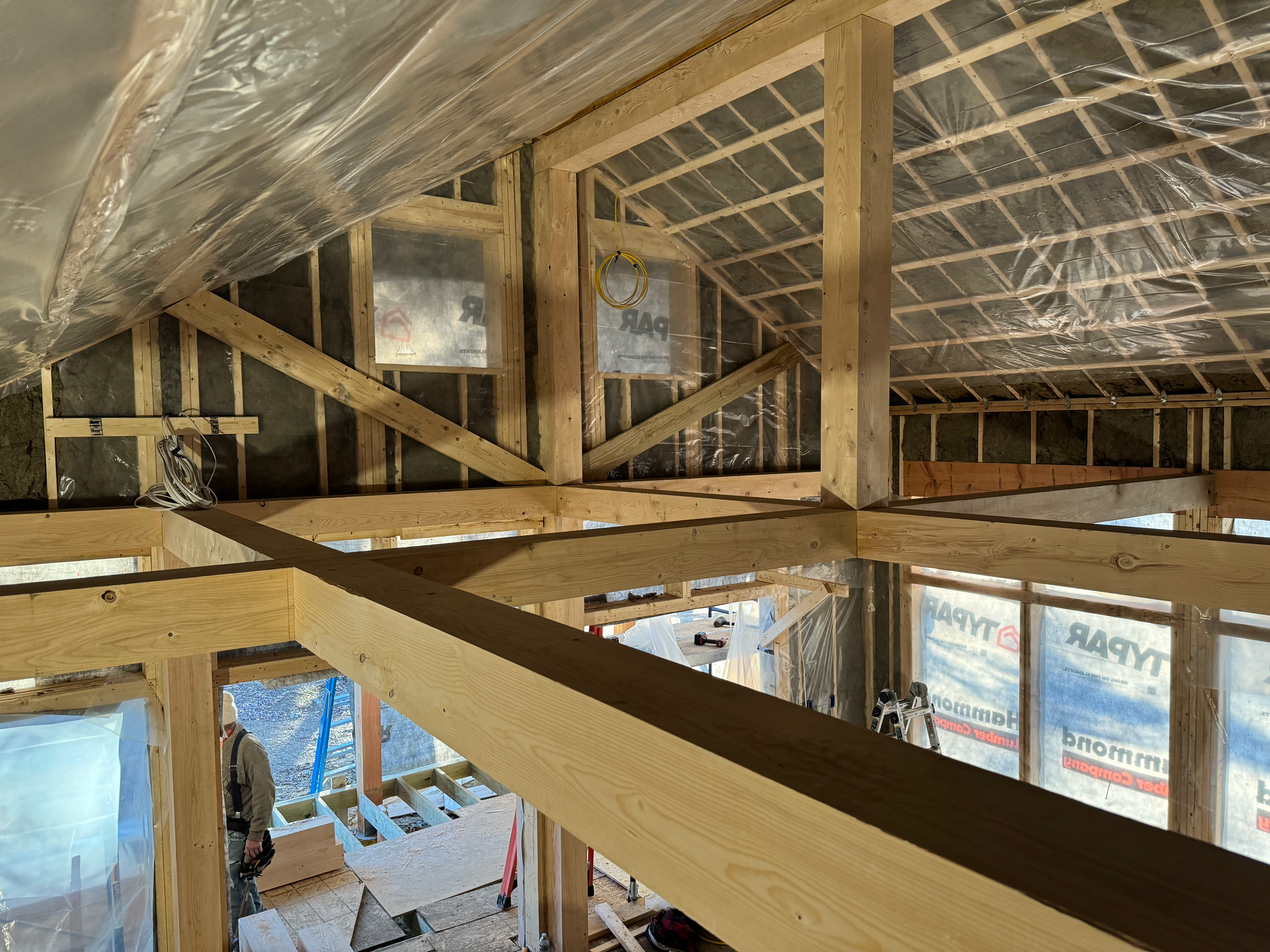 the inside of a building under construction with timber beams