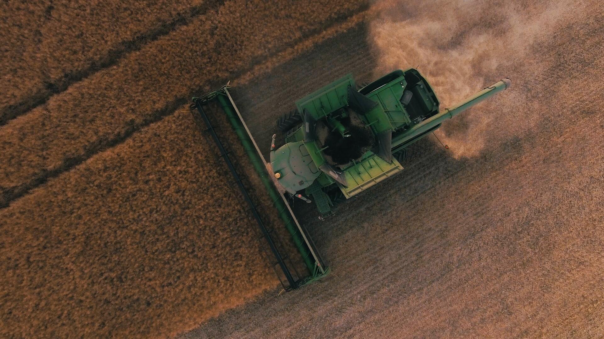 An Aerial View of A Combine Harvester Working in A Field — Earthmoving Rentals Pty Ltd in Yatala, QLD