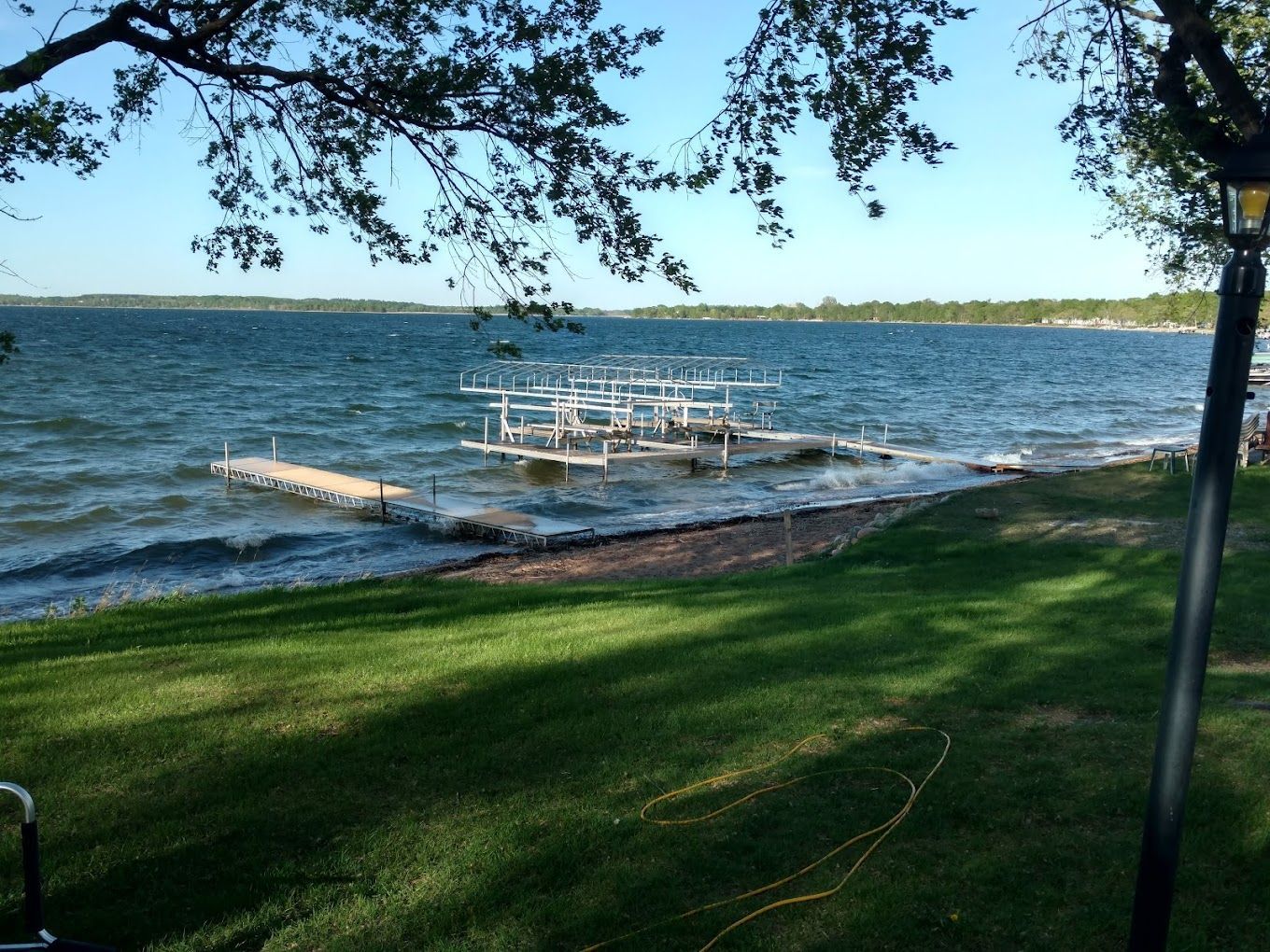 A large body of water with a dock in the foreground