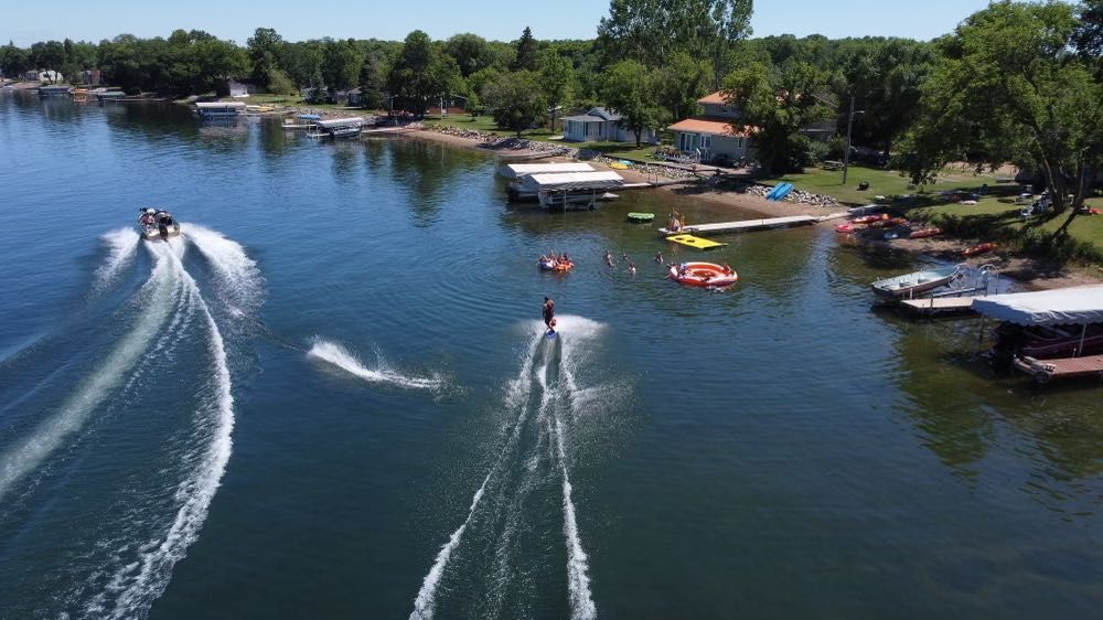 A group of people are water skiing on a lake.