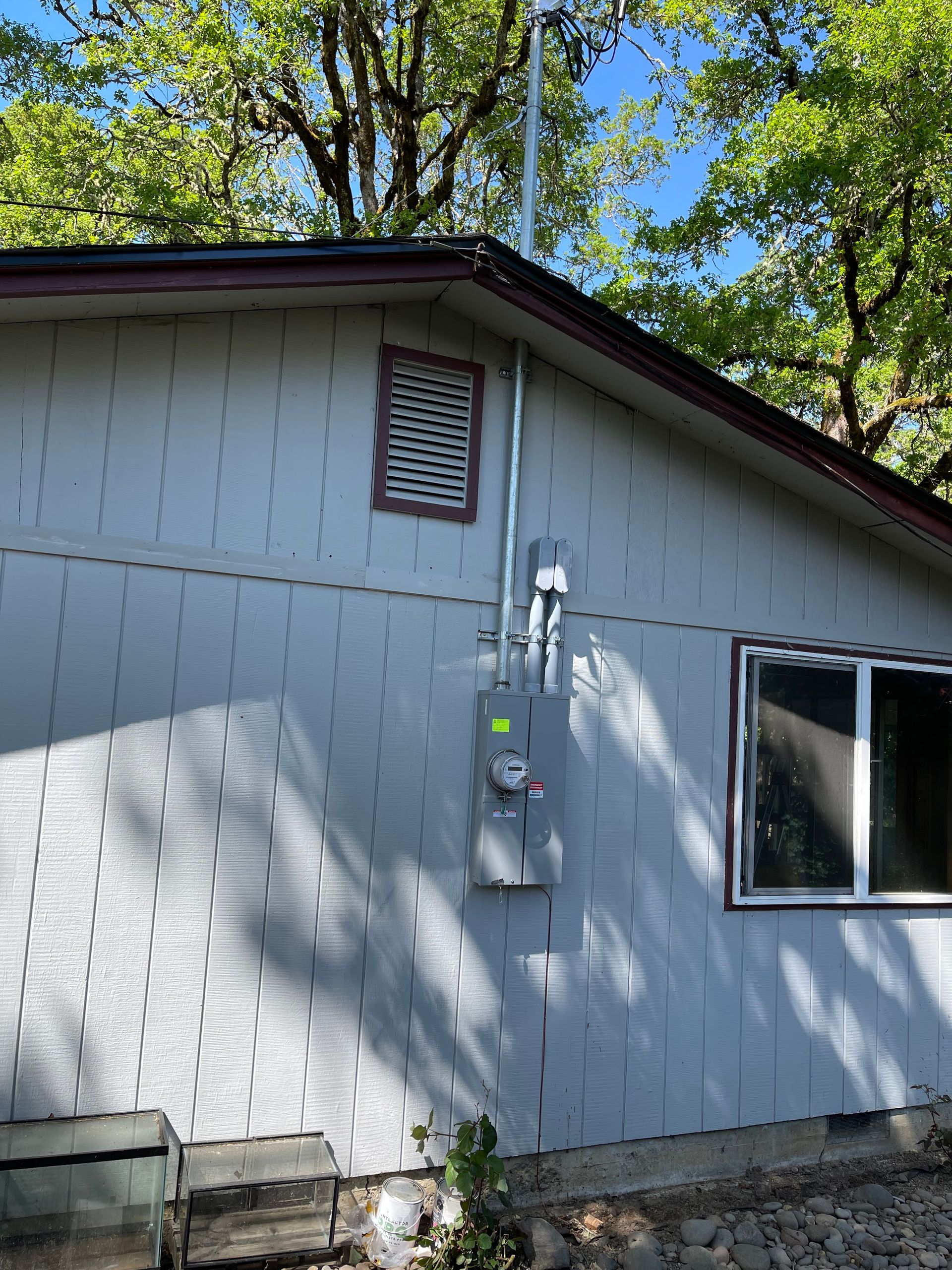 Freedom Electric Construction- A house with a window and a box on the side of it