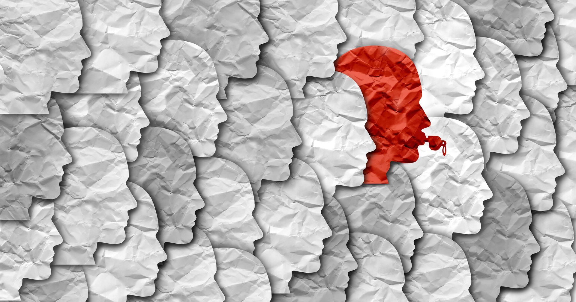 Red silhouette head blowing a whistle stands out from a crowd of white paper-like head silhouettes.