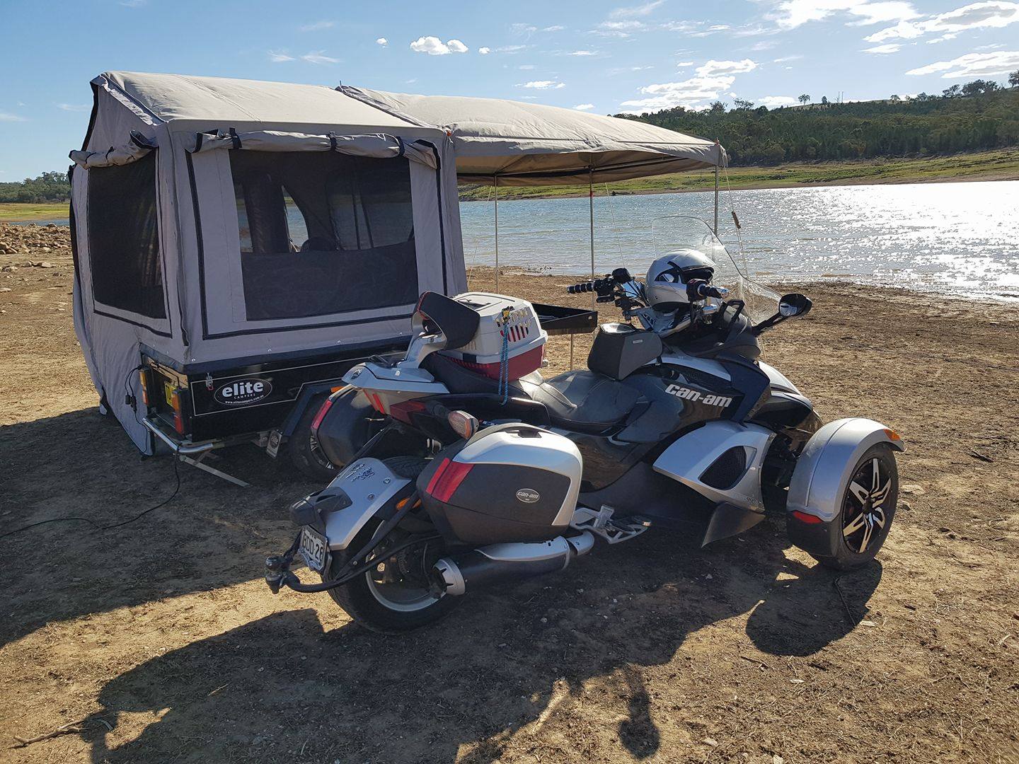 a trike beside an Elite Camper Trailer
