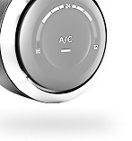 Close-up of a car's A/C control dial. Numbers 16 to 34 are displayed, and 
