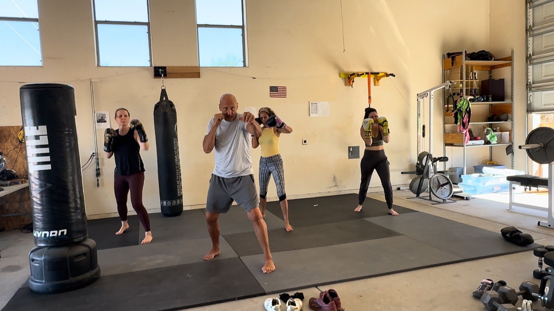 Yoga instructor guides students in a studio; poses include side bends.