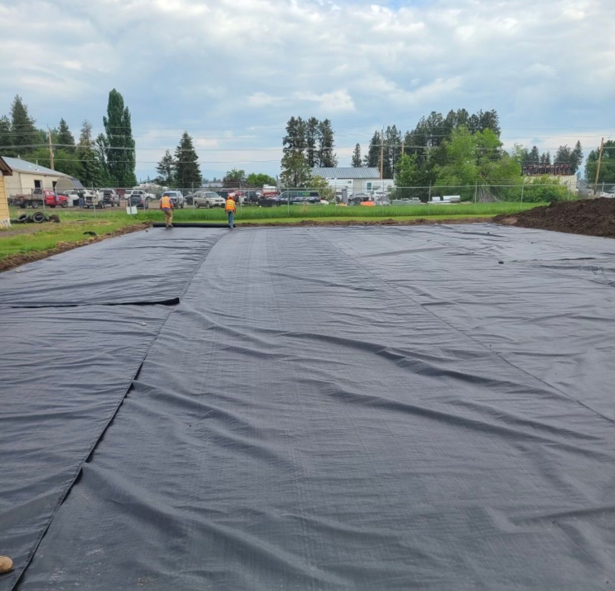 A large black tarp is covering a large area