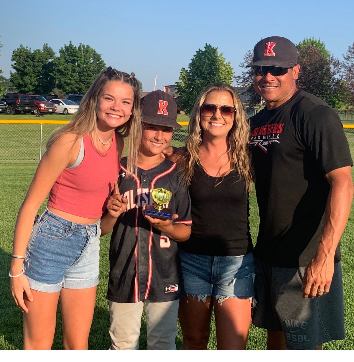 A group of people posing for a picture with one wearing a jersey that says mus