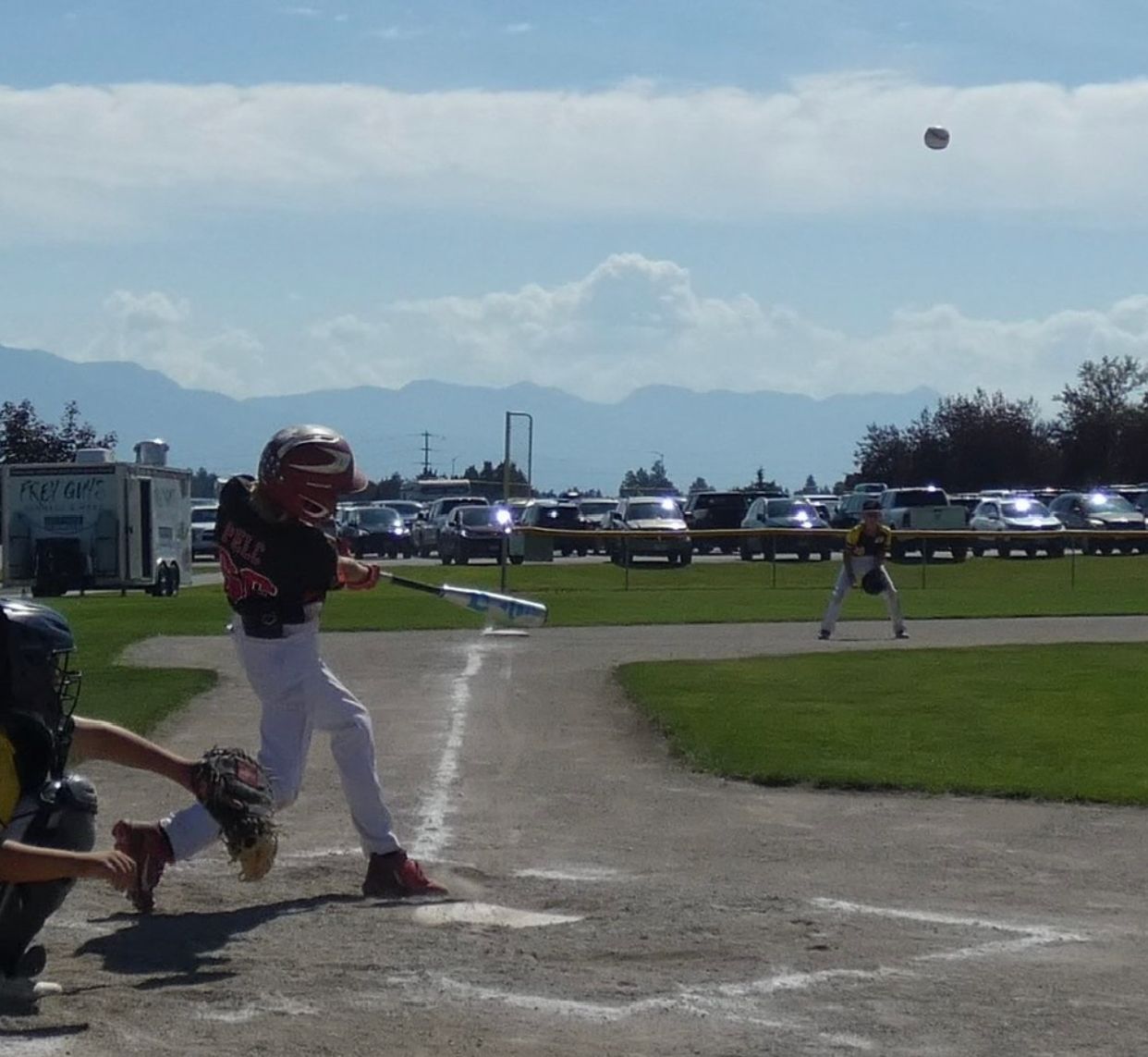 A baseball game is being played on a sunny day