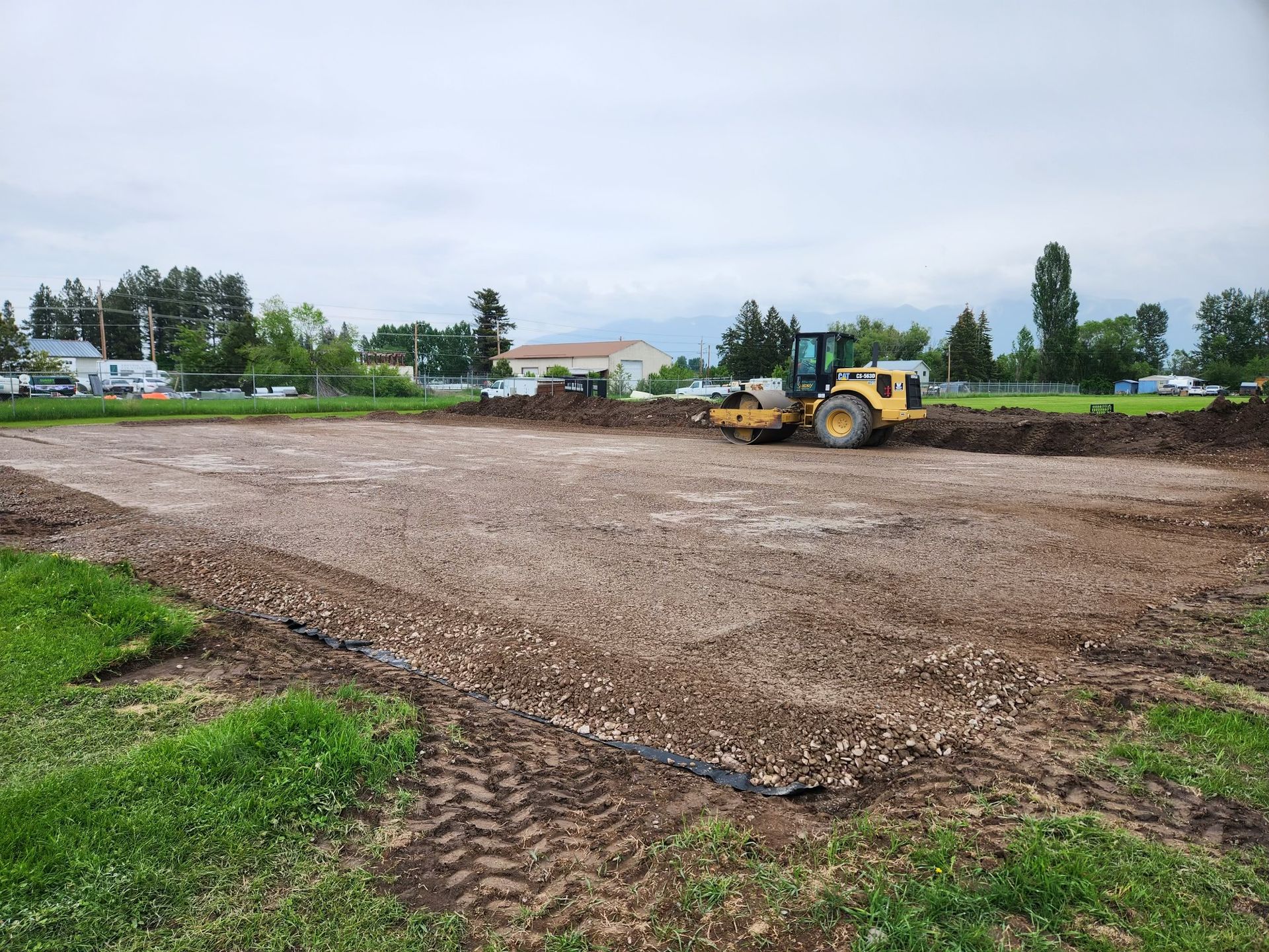 A bulldozer is moving dirt in a field.