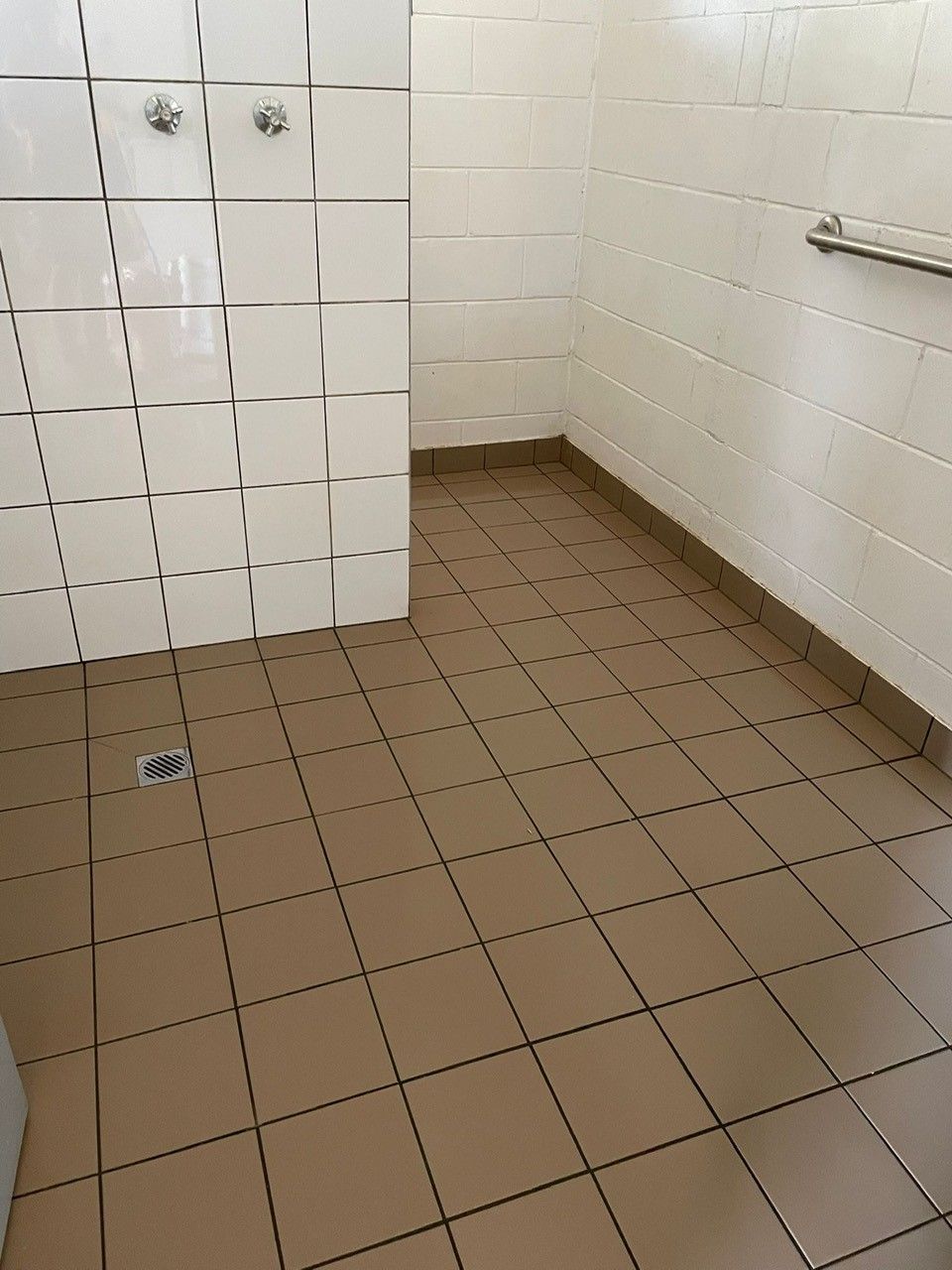 A Bathroom With A Tiled Floor And White Walls — Regina's Cleaning Group Pty Ltd In Lee Point, NT