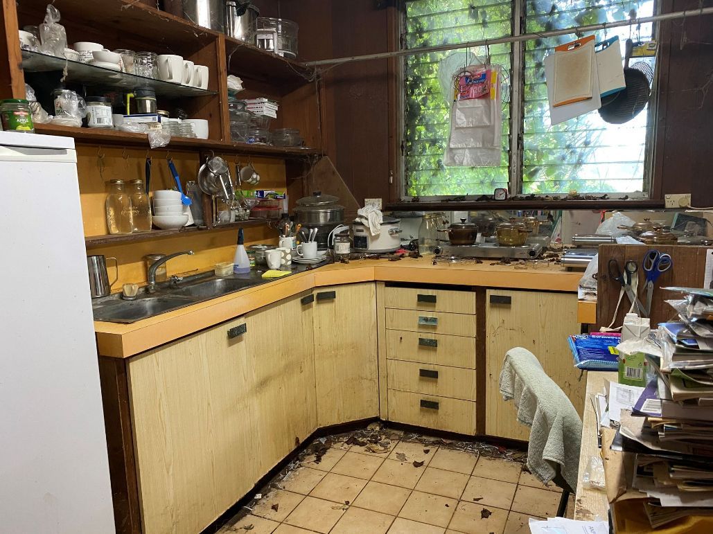 A Messy Kitchen With A Sink, Cabinets, And A Refrigerator — Regina's Cleaning Group Pty Ltd In Lee Point, NT