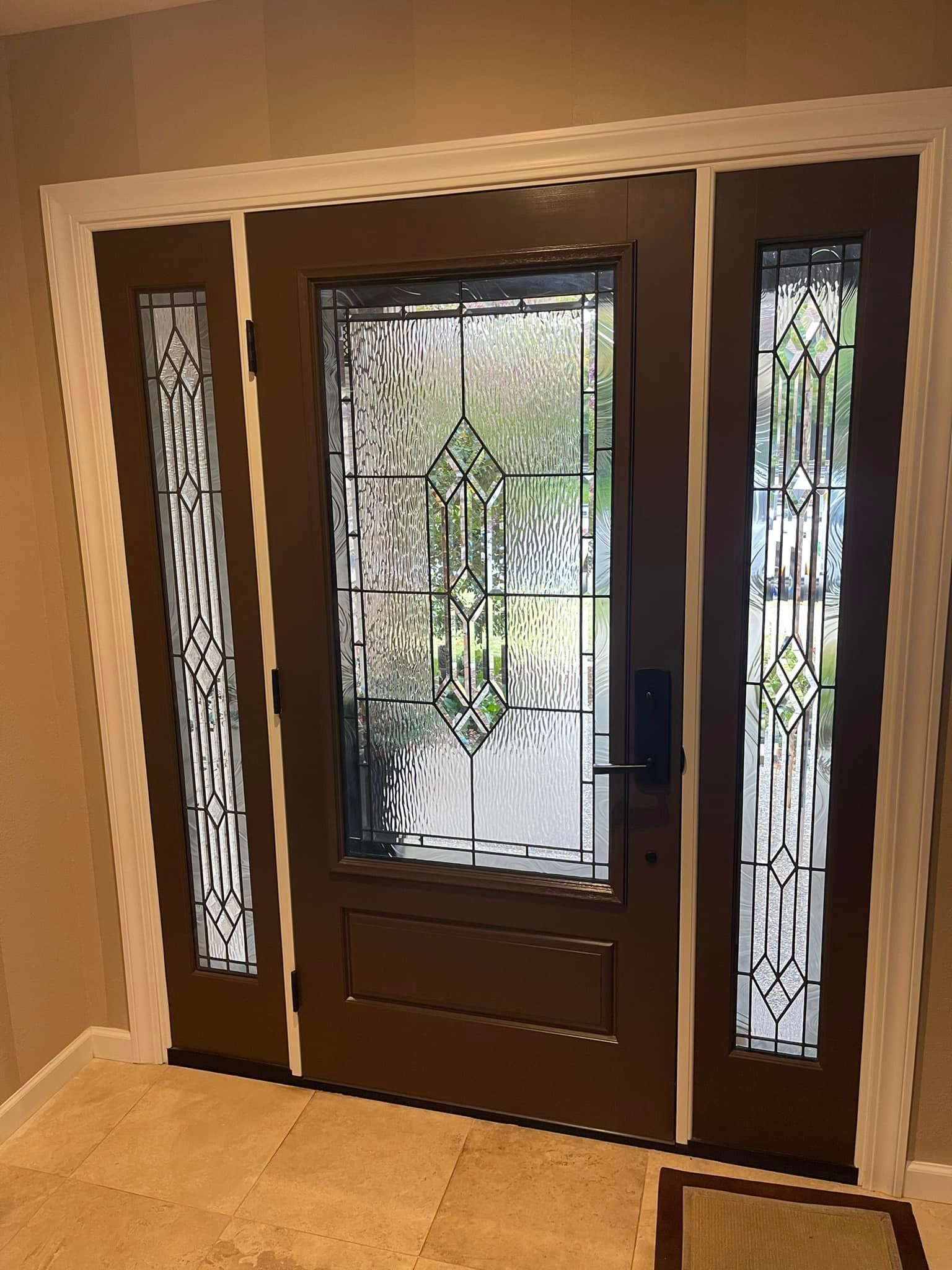 A brown door with stained glass windows in a hallway.