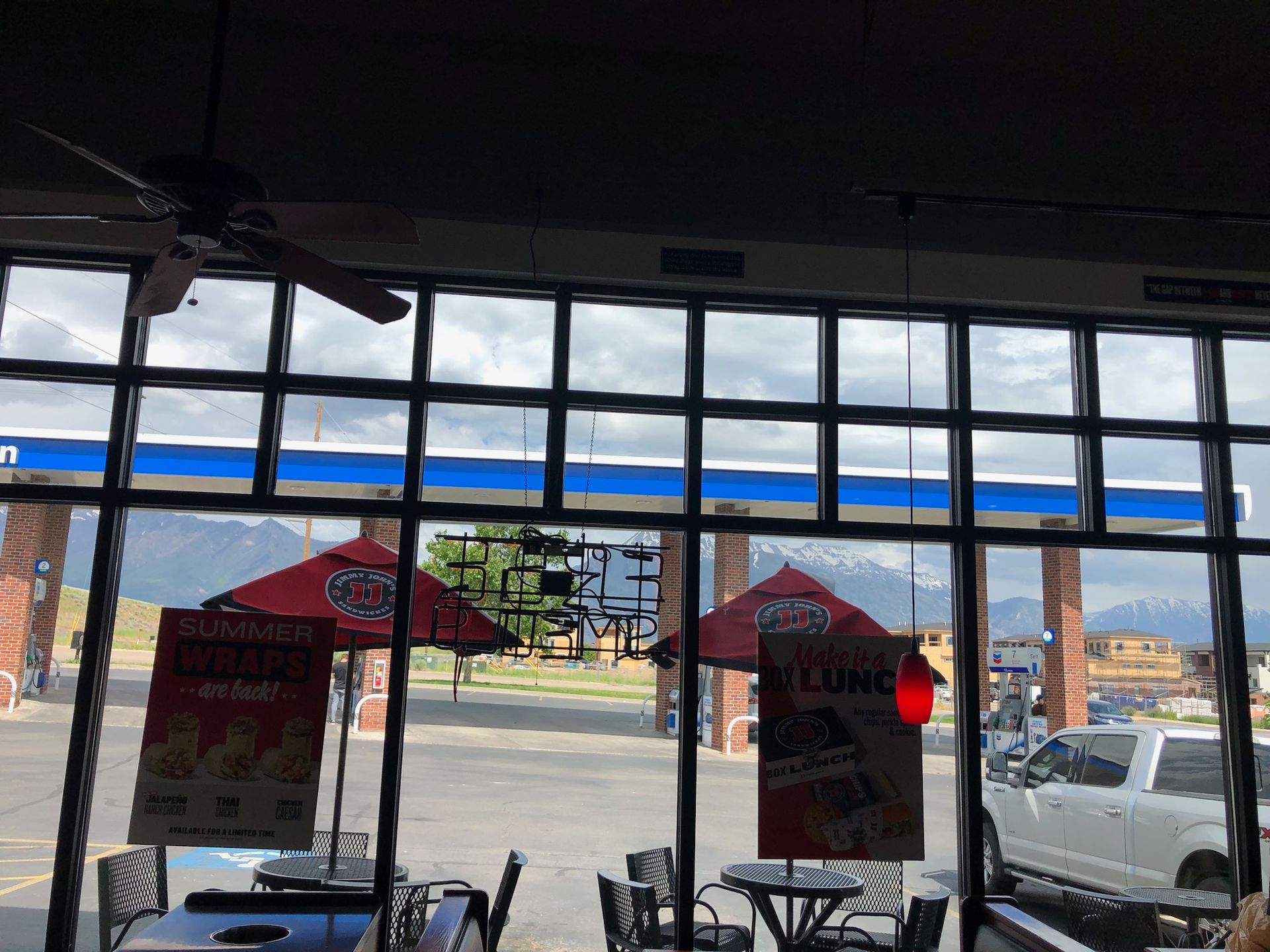 A restaurant with full length windows with square cutout windows on the upper half.