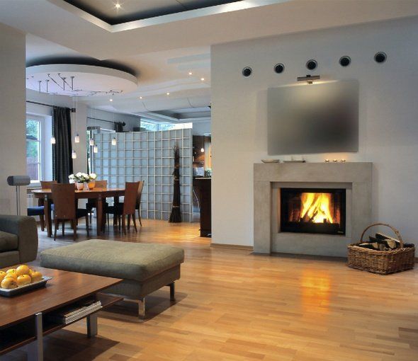 Living room with fireplace, wooden floors, dining table, and modern decor.