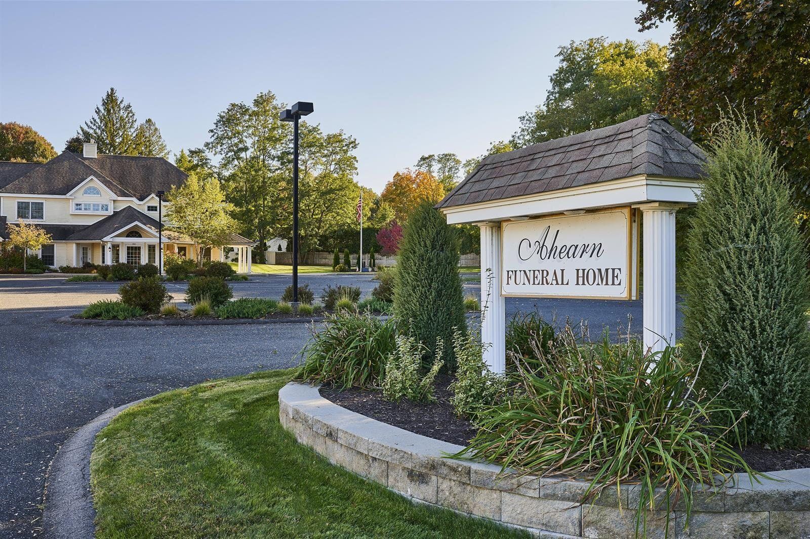 A sign for a funeral home is in front of a house