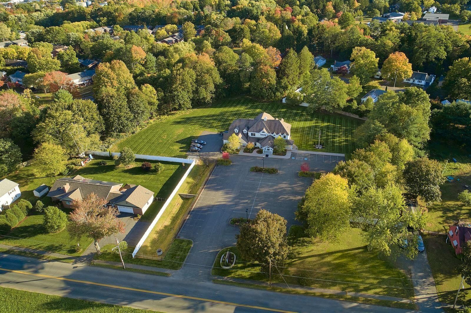 An aerial view of a residential area with lots of trees and houses