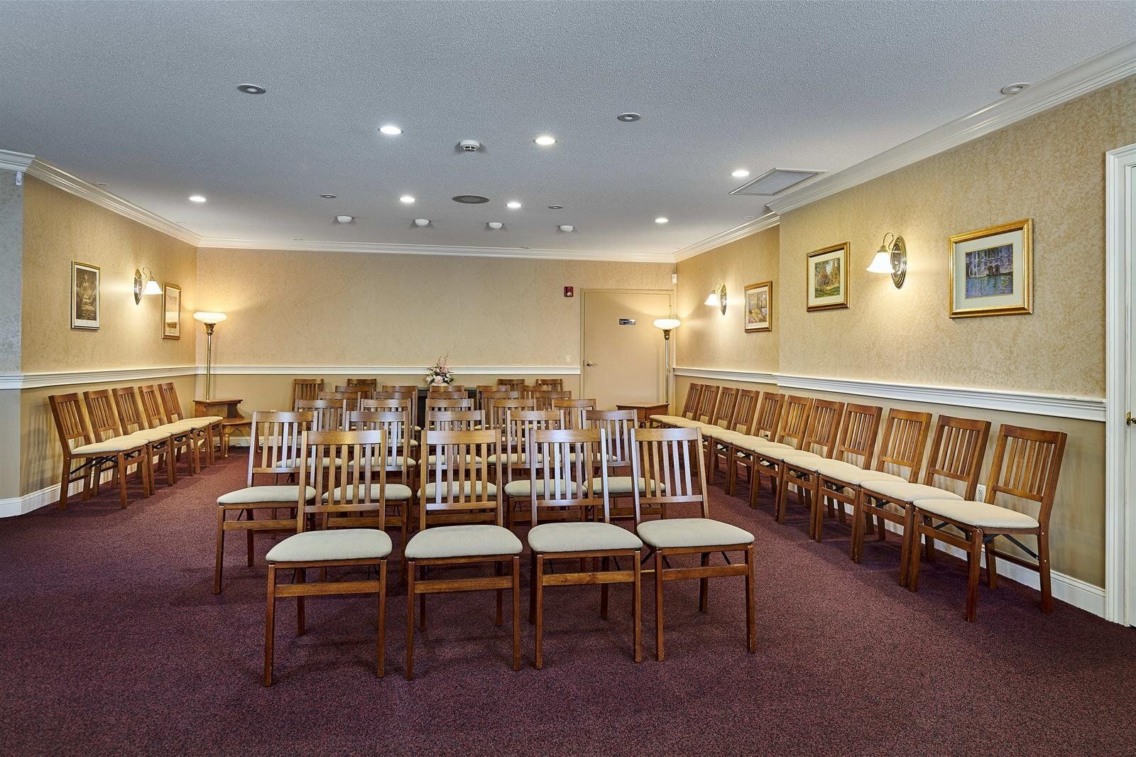 A large room with rows of chairs in it.