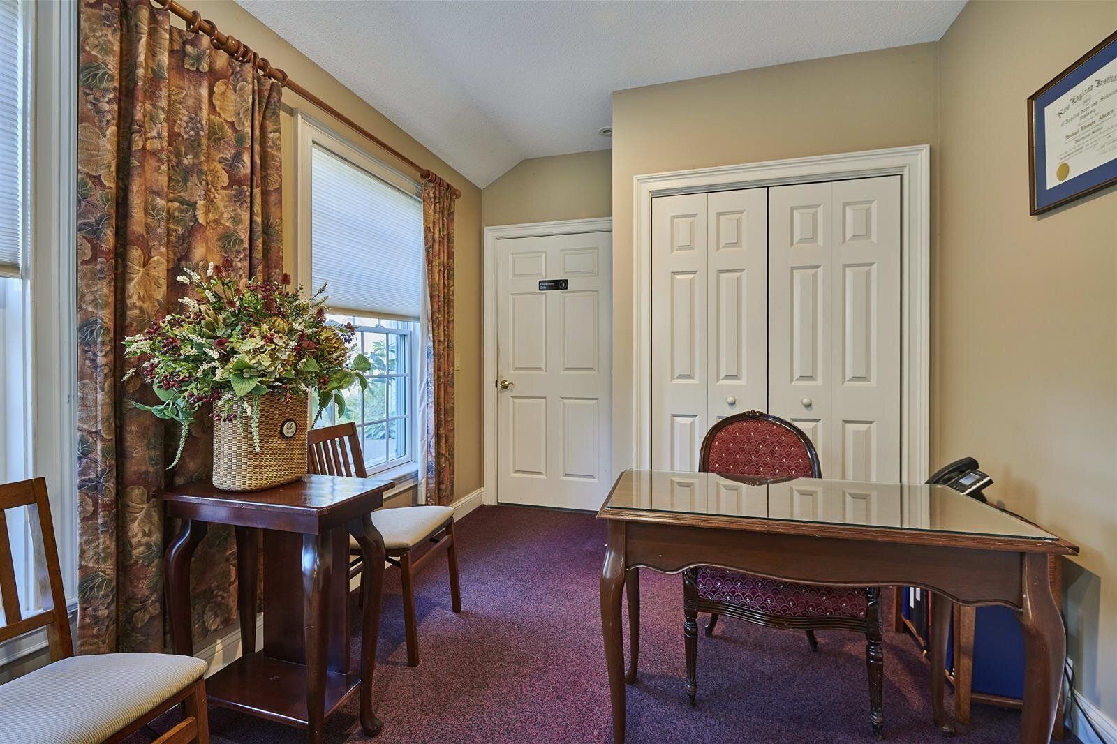 A room with a table and chairs in it