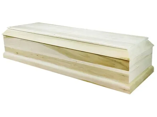 A wooden coffin is sitting on a white surface.