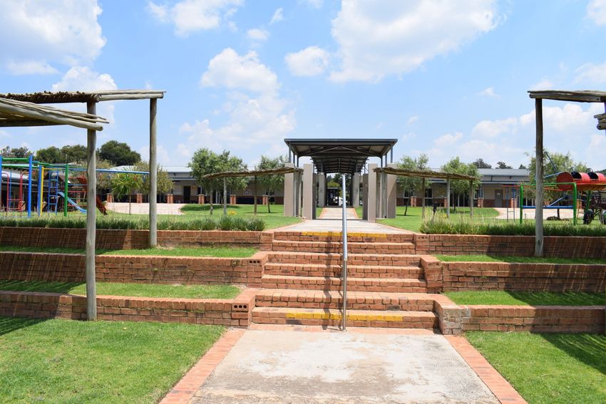 a park with stairs and a playground in the background