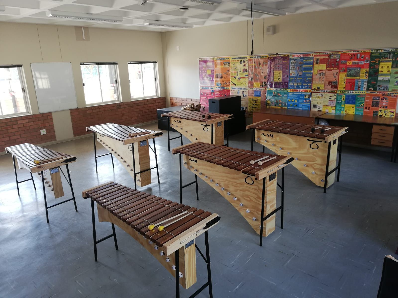 a group of wooden xylophones are lined up in a classroom .