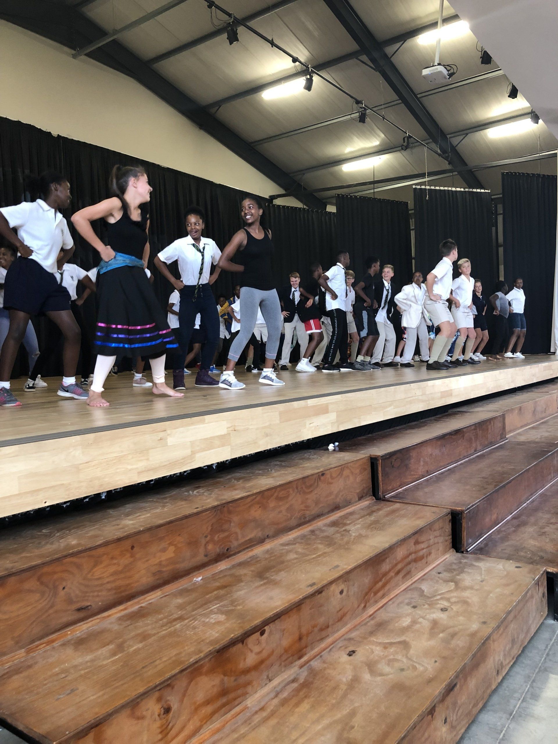 a group of people are dancing on a stage .