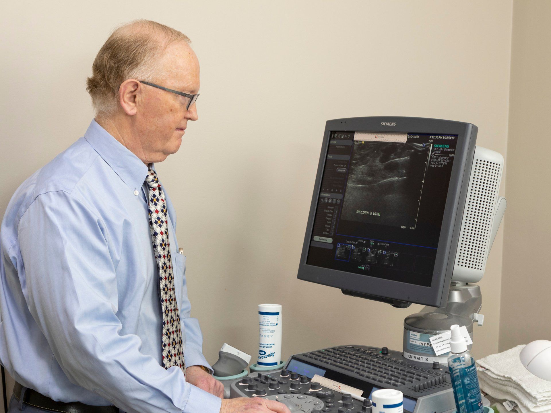 A doctor looking at the breast ultrasound