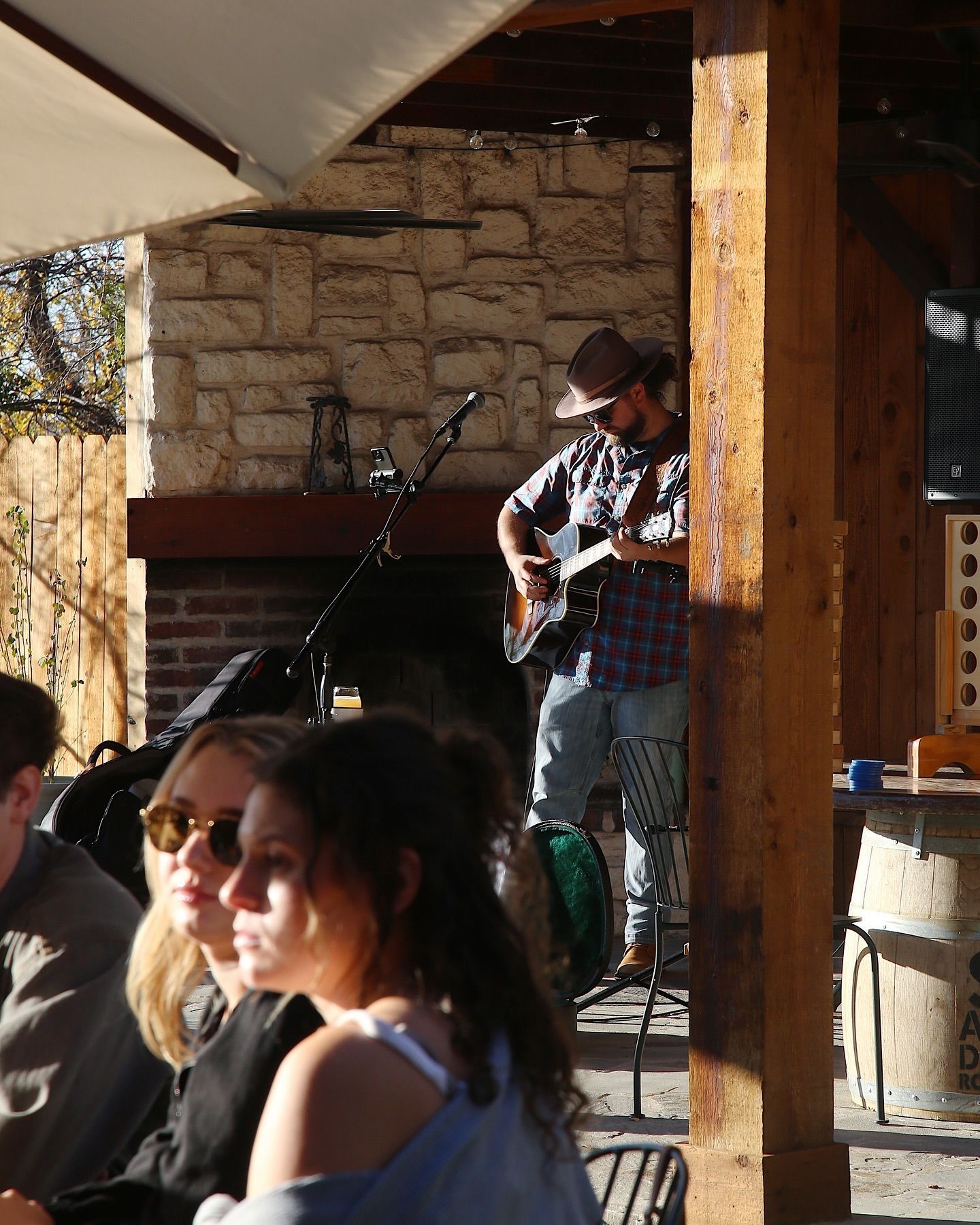 A man playing a guitar in front of a group of people