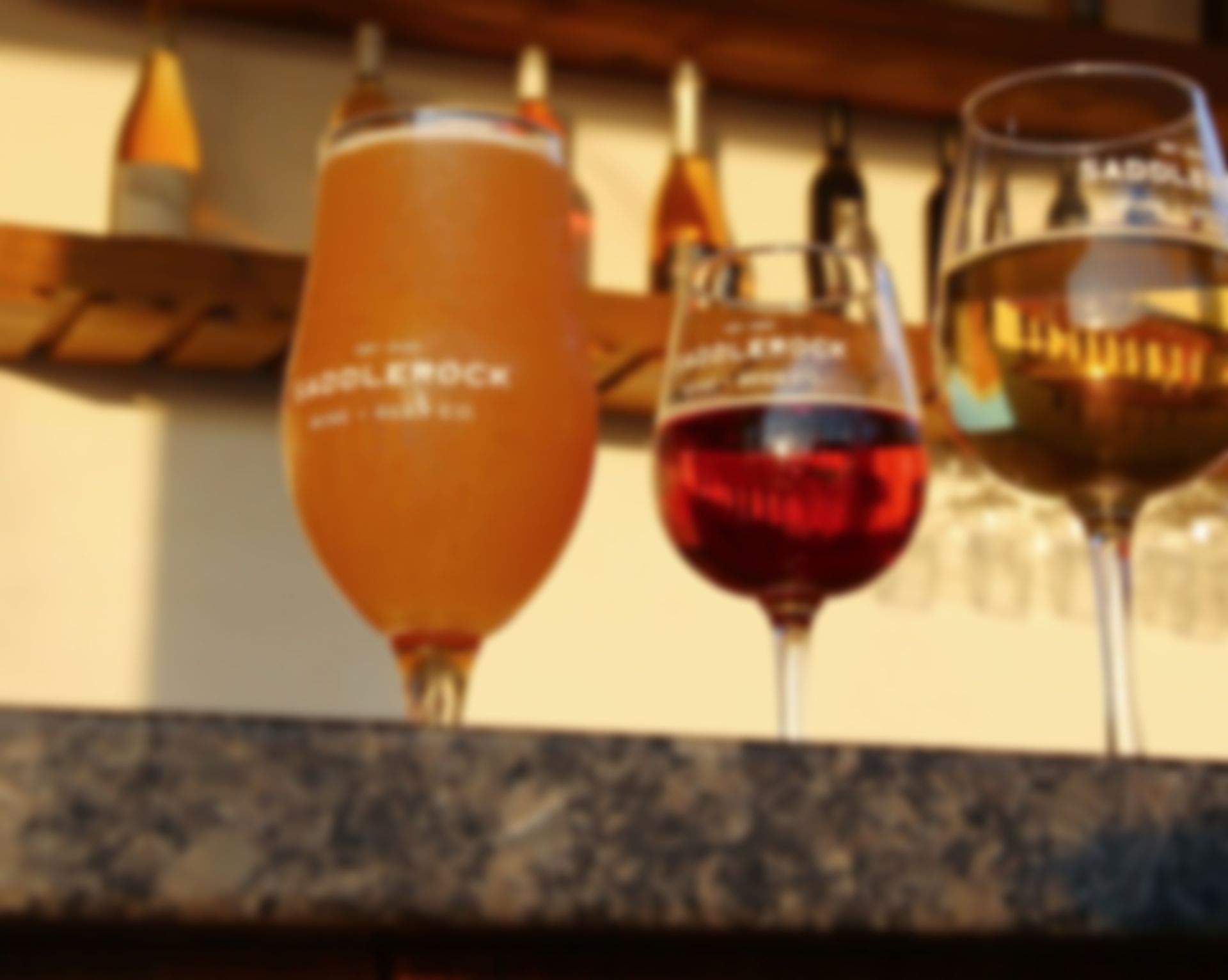 Three wine glasses with one that says applerock on it